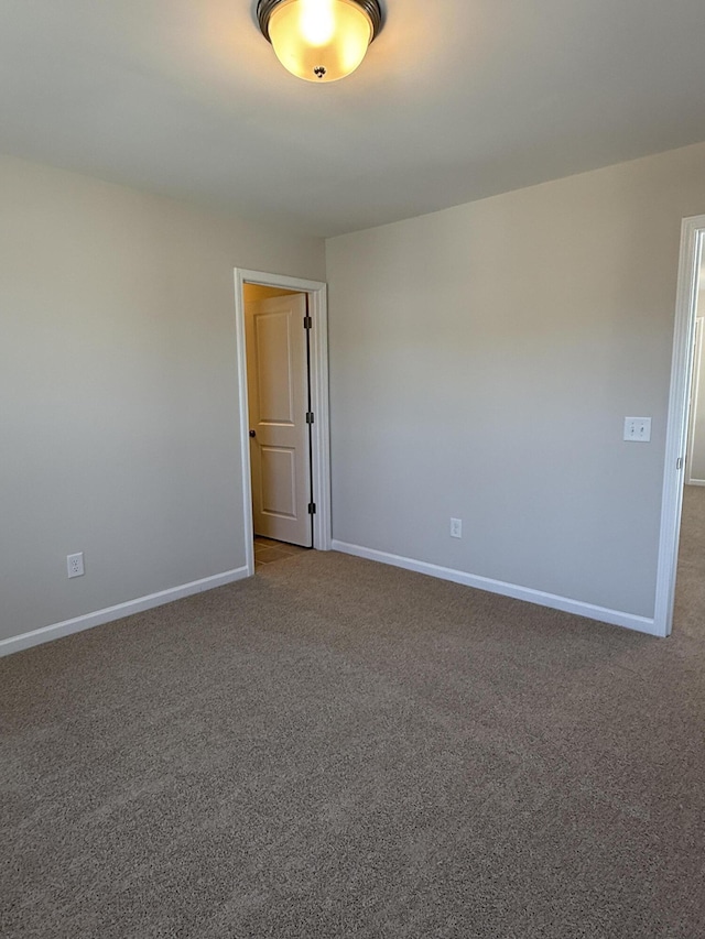 empty room with baseboards and carpet floors