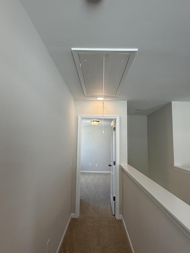 hall with baseboards, attic access, an upstairs landing, and carpet flooring