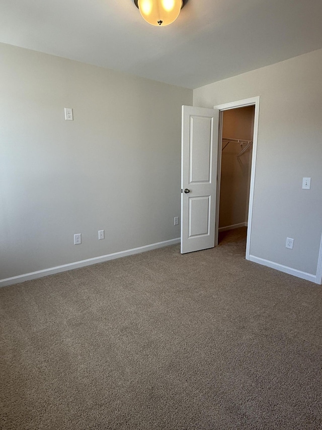 empty room featuring baseboards and carpet floors