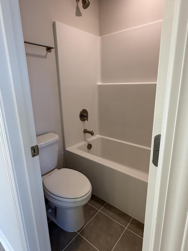 bathroom featuring tile patterned floors, toilet, and shower / tub combination