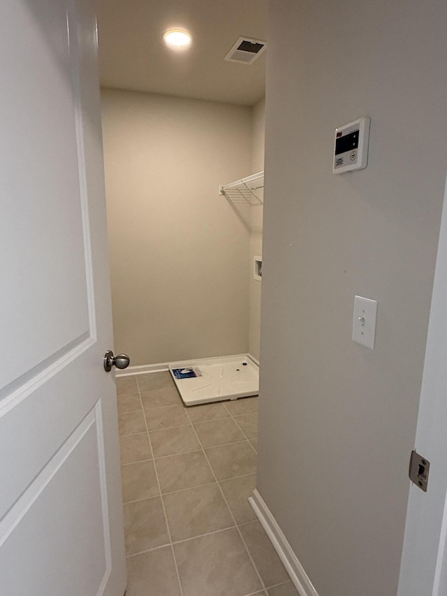 laundry area featuring visible vents, light tile patterned floors, baseboards, hookup for a washing machine, and laundry area