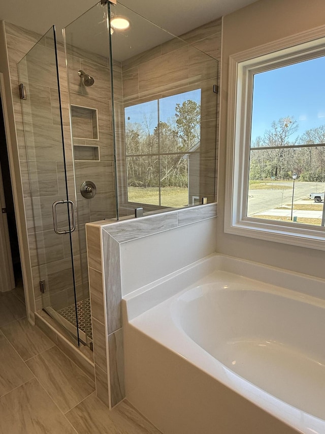 full bath featuring a garden tub and a stall shower