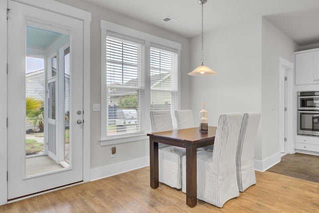 dining area featuring light wood-type flooring