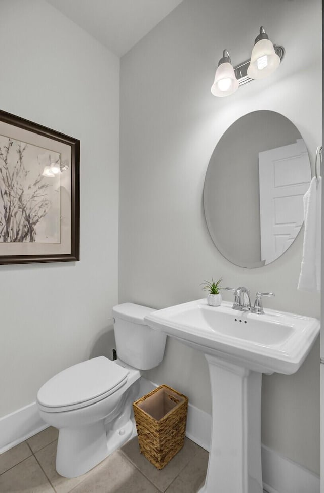 bathroom with tile patterned floors, toilet, and sink