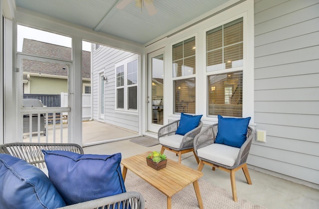 sunroom / solarium featuring ceiling fan