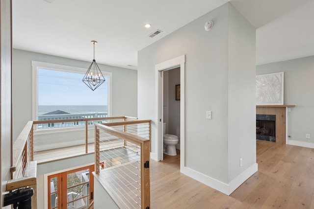 1568 E Ashley Ave, Folly Beach, SC 29439 - hallway with a chandelier, light wood finished floors, baseboards, an upstairs landing, and recessed lighting