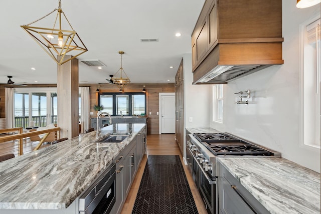 1568 E Ashley Ave, Folly Beach, SC 29439 - kitchen featuring a sink, appliances with stainless steel finishes, dark wood-type flooring, gray cabinetry, and a large island