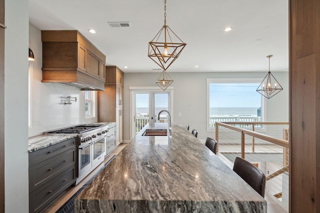 1568 E Ashley Ave, Folly Beach, SC 29439 - kitchen with range with two ovens, a chandelier, a sink, recessed lighting, and a large island