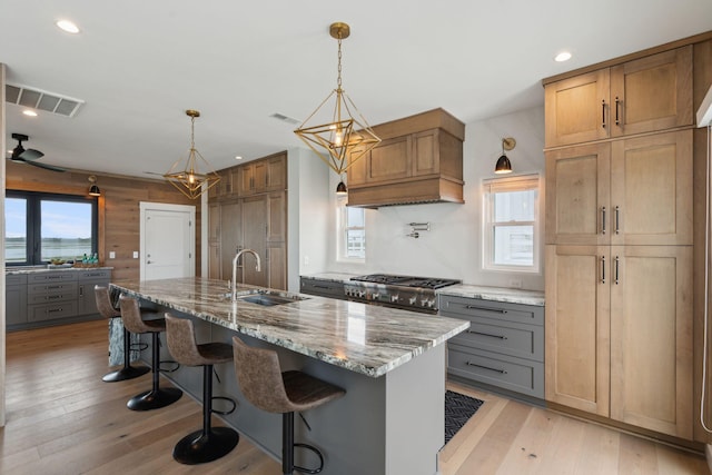 1568 E Ashley Ave, Folly Beach, SC 29439 - kitchen with plenty of natural light, a sink, range, light stone counters, and recessed lighting