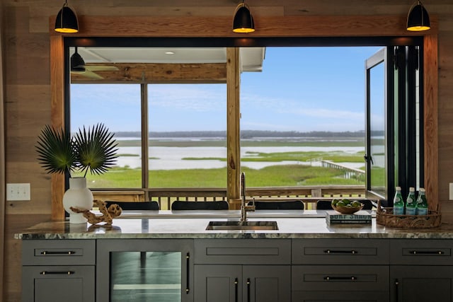 1568 E Ashley Ave, Folly Beach, SC 29439 - bar with a sink, beverage cooler, a water view, and hanging light fixtures