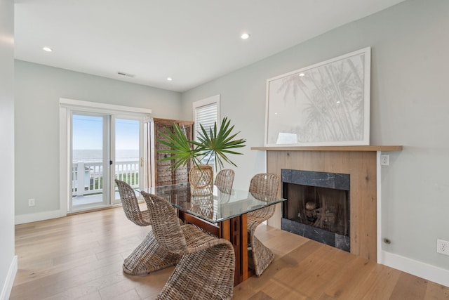 1568 E Ashley Ave, Folly Beach, SC 29439 - dining area with baseboards, wood finished floors, a fireplace, and recessed lighting