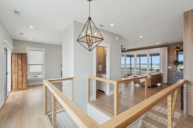 1568 E Ashley Ave, Folly Beach, SC 29439 - hall with an upstairs landing, wood finished floors, a chandelier, recessed lighting, and a water view