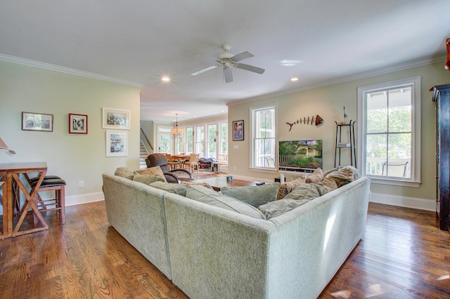 living room with ornamental molding, dark hardwood / wood-style flooring, and ceiling fan