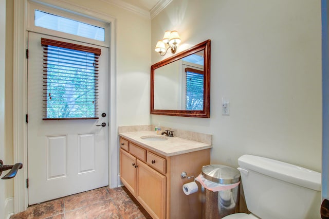 bathroom featuring vanity with extensive cabinet space, ornamental molding, toilet, and tile flooring