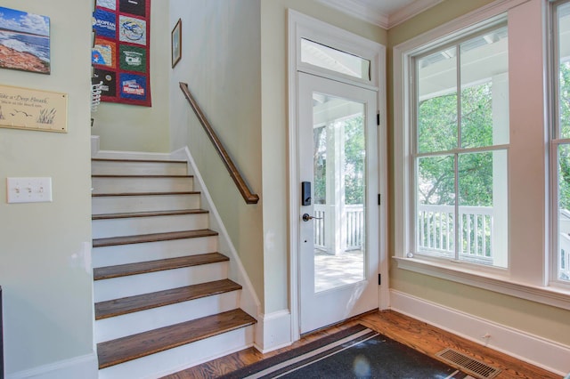 entrance foyer with crown molding and wood-type flooring