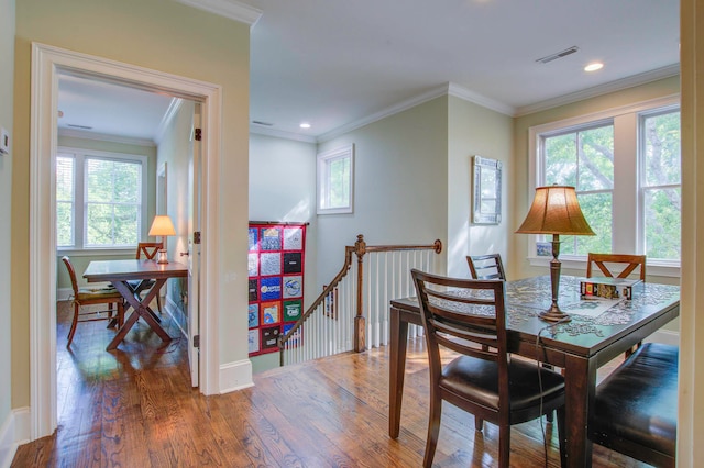 dining room featuring hardwood / wood-style floors and crown molding