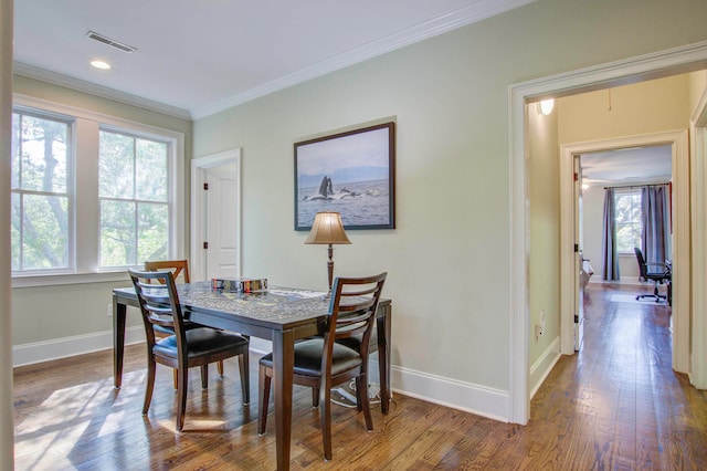 dining room featuring dark hardwood / wood-style floors and ornamental molding