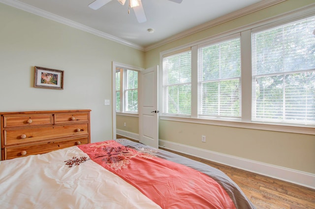 bedroom featuring ceiling fan, crown molding, and hardwood / wood-style flooring