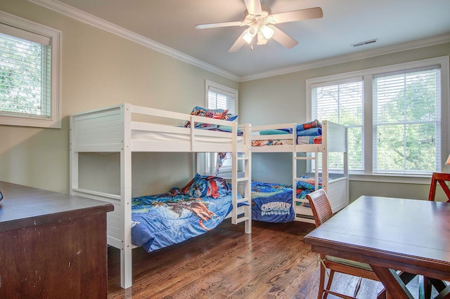 bedroom with dark hardwood / wood-style floors, ceiling fan, and ornamental molding