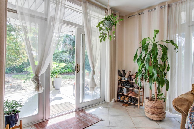 doorway to outside with a healthy amount of sunlight and light tile floors