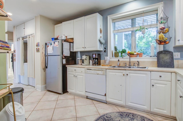 kitchen featuring white cabinets, sink, dishwasher, and light tile floors