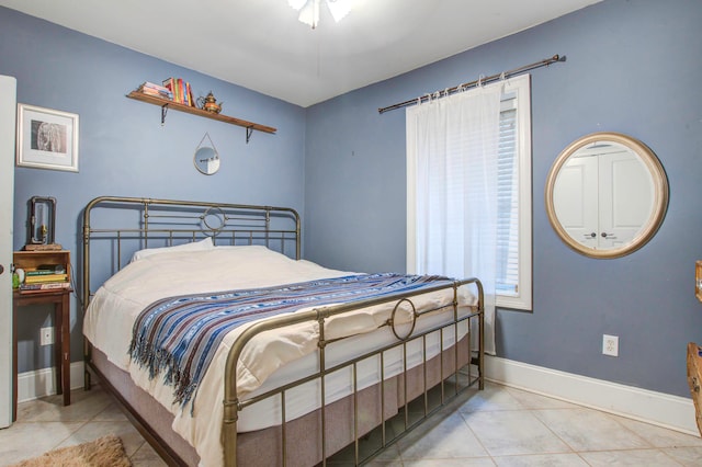 tiled bedroom featuring ceiling fan