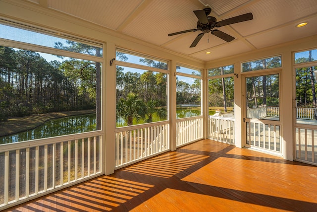 unfurnished sunroom with a water view, coffered ceiling, and ceiling fan