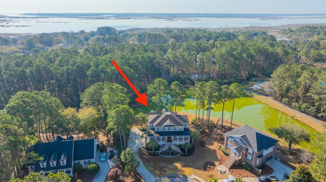 bird's eye view with a view of trees and a water view