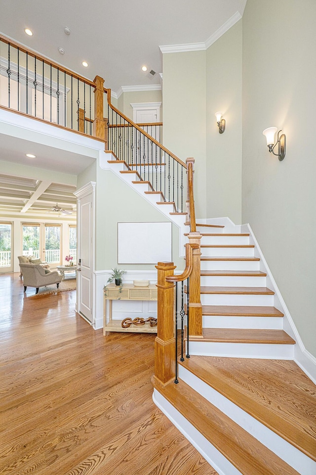 staircase featuring visible vents, crown molding, ceiling fan, recessed lighting, and wood finished floors