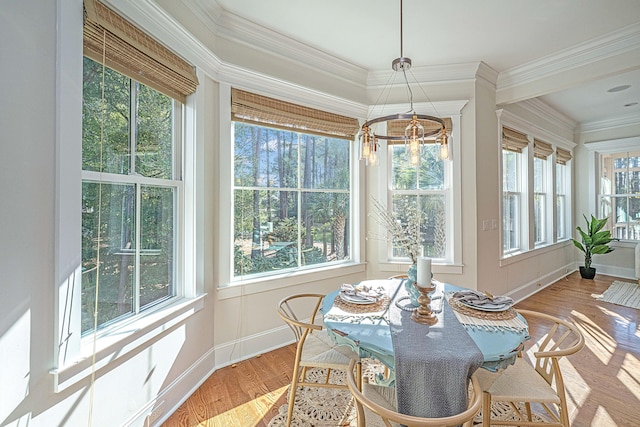 sunroom / solarium with a chandelier