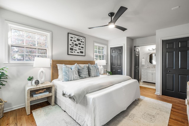 bedroom featuring ensuite bathroom, wood-type flooring, and ceiling fan