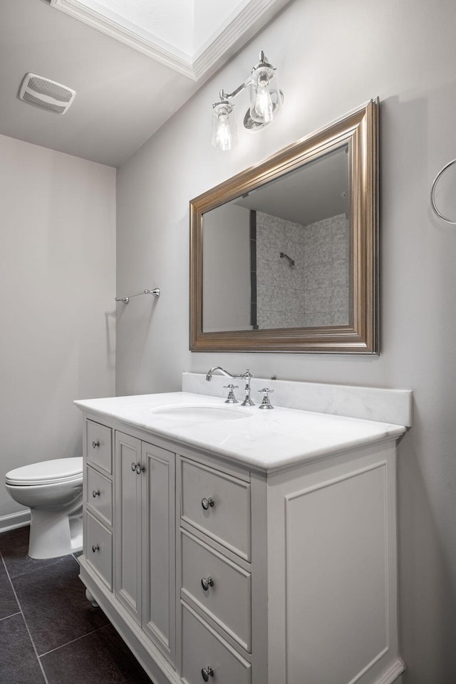 bathroom featuring vanity, toilet, and tile patterned flooring