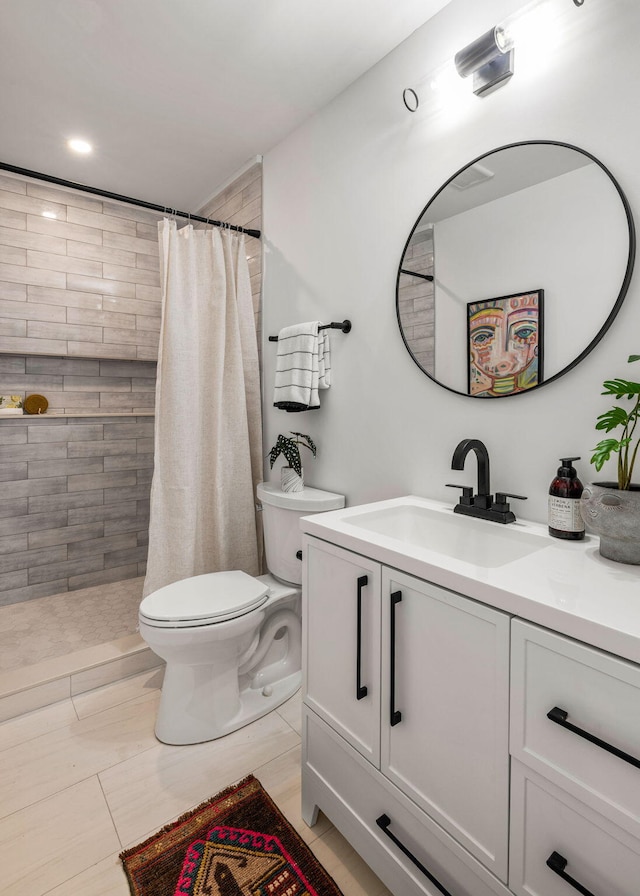 bathroom with vanity, a shower with shower curtain, and toilet