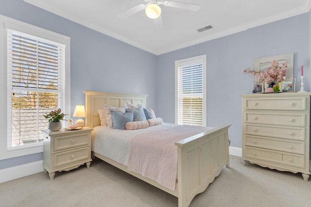 bedroom with ornamental molding, light colored carpet, multiple windows, and ceiling fan