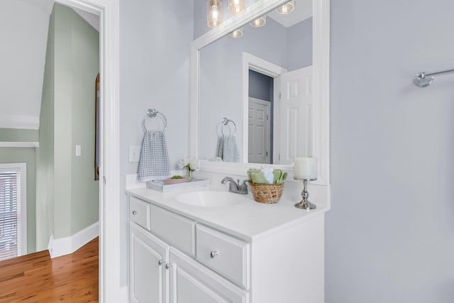 bathroom with hardwood / wood-style floors and vanity