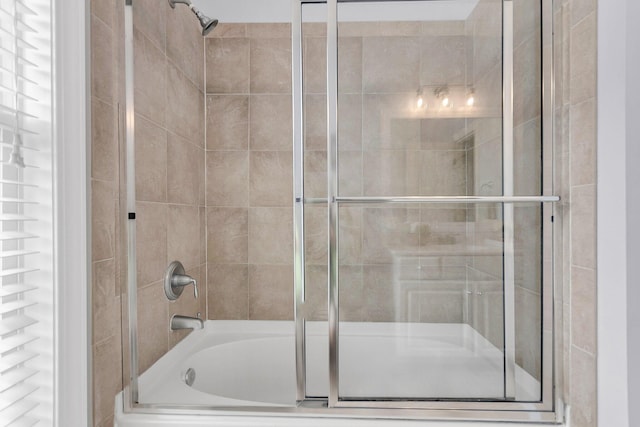 bathroom featuring shower / bath combination with glass door