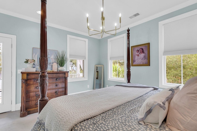 carpeted bedroom featuring a chandelier and ornamental molding