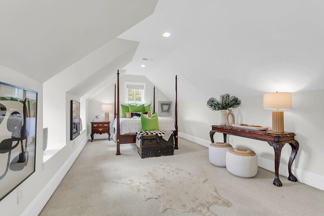 bedroom with vaulted ceiling and light colored carpet