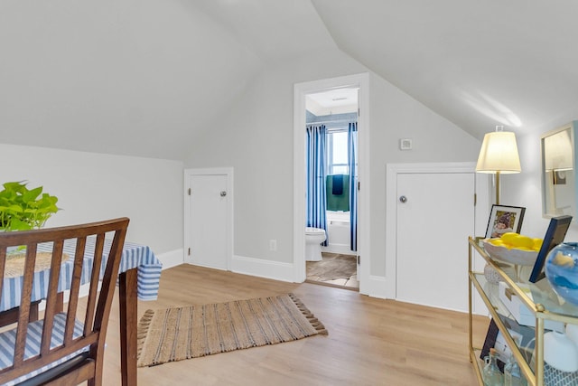 interior space featuring light hardwood / wood-style flooring and vaulted ceiling