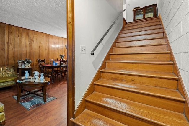 12 Grove St, Charleston, SC 29403 - staircase featuring wood finished floors, wooden walls, and a textured ceiling