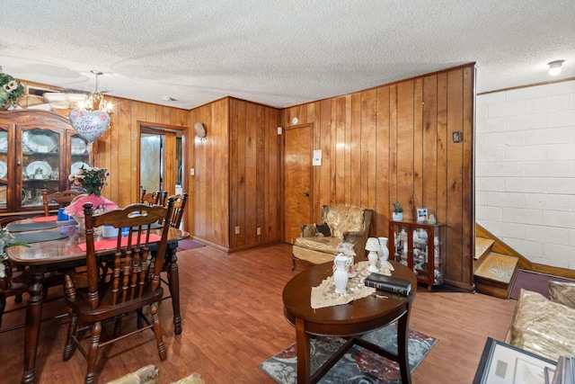 12 Grove St, Charleston, SC 29403 - living room with a textured ceiling, wood finished floors, wood walls, and a chandelier