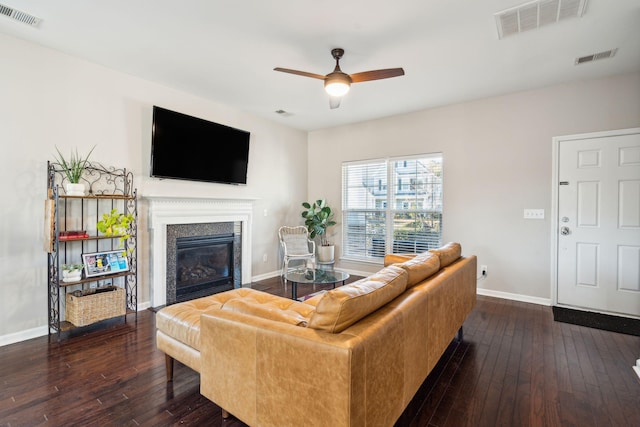 living room with dark hardwood / wood-style flooring and ceiling fan