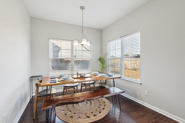 dining area featuring an inviting chandelier and dark hardwood / wood-style floors