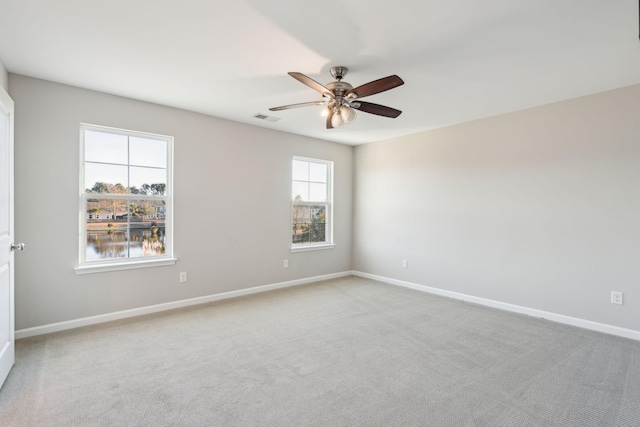 empty room featuring carpet floors and ceiling fan