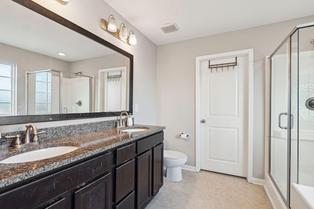 bathroom with toilet, a shower with door, and vanity