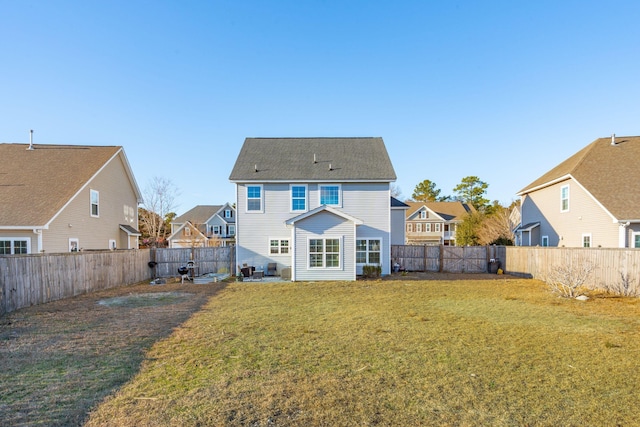 rear view of house with a yard