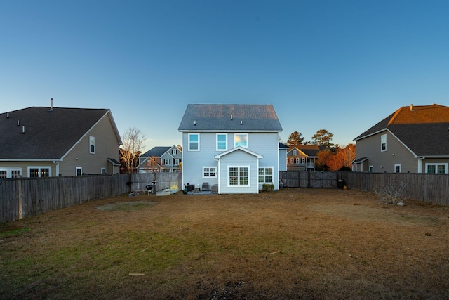 rear view of property featuring a yard