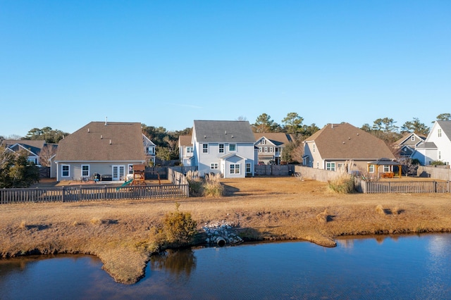 rear view of property with a water view