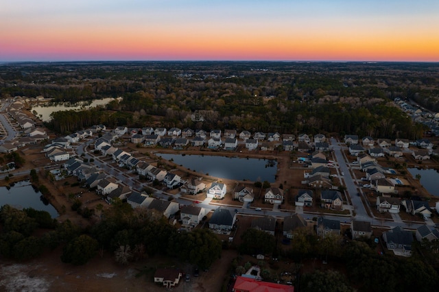 aerial view at dusk with a water view