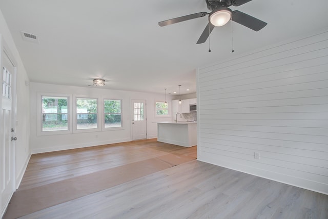 2135 Clayton St, Charleston, SC 29414 - unfurnished living room featuring light wood-style flooring, a sink, baseboards, and ceiling fan